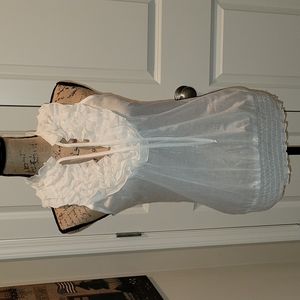 Sleeveless women's ruffle Vneck w/ties. Has elastic around the bottom adjustable